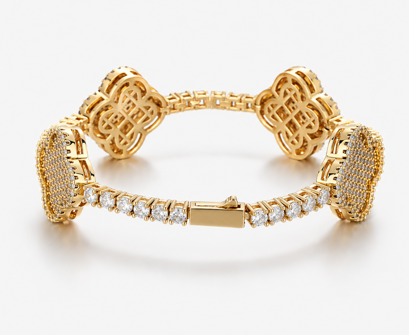 Gold-tone four-leaf clover bracelet laid open, showing the pave clover stations and plain box clasp